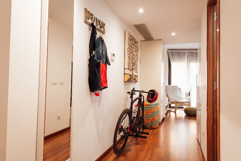 Entrance of a Little Home Girona apartment with a bicycle stored inside